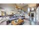 Open-concept living room with staircase and fireplace, connected to an updated kitchen with island at 8338 Hunters Meadow Way, Indianapolis, IN 46259