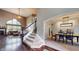 Inviting living room and dining area featuring a fireplace, staircase, and hardwood floors at 8338 Hunters Meadow Way, Indianapolis, IN 46259