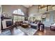 Spacious living room boasts a fireplace, large windows, hardwood floors, and opens to the kitchen at 8338 Hunters Meadow Way, Indianapolis, IN 46259