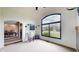 Bright living room featuring large window and hardwood floors, adjacent to the dining area at 8338 Hunters Meadow Way, Indianapolis, IN 46259
