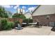 Backyard patio with basketball hoop, outdoor seating, and lush greenery, perfect for outdoor activities at 8338 Hunters Meadow Way, Indianapolis, IN 46259