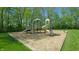 Community playground with slides, climbing equipment and mulch surfacing in a wooded area at 8338 Hunters Meadow Way, Indianapolis, IN 46259