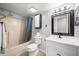 Well-lit bathroom features a shower-tub combo and a sleek vanity with a framed mirror at 8416 Buckingham Dr, Columbus, IN 47201