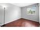 Cozy bedroom features hardwood floors, neutral paint, and a window providing natural light at 8416 Buckingham Dr, Columbus, IN 47201