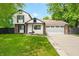 Charming two-story home featuring white siding, brick accents, and a well-manicured lawn at 8416 Buckingham Dr, Columbus, IN 47201