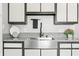 Close-up of kitchen sink with granite countertop and updated white cabinets and stainless steel faucet at 8416 Buckingham Dr, Columbus, IN 47201