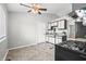 Bright kitchen with white and black cabinets, stainless steel appliances, and tile flooring at 8416 Buckingham Dr, Columbus, IN 47201