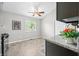 Bright eat-in kitchen with gray walls, tile floors, ceiling fan, and updated cabinets and countertops at 8416 Buckingham Dr, Columbus, IN 47201