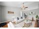 A bright living room features vaulted ceilings, hardwood floors, modern furniture, and plenty of natural light at 8416 Buckingham Dr, Columbus, IN 47201