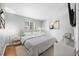 Staged main bedroom with carpet, queen bed, nightstands, art, and lamp at 8416 Buckingham Dr, Columbus, IN 47201