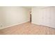 Bedroom featuring wood-look floors, an adjacent bathroom and a closet with gold hardware at 8503 Canterbury W Sq # D, Indianapolis, IN 46260