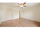 Empty bedroom with wood-look floors, white walls, and a ceiling fan with a light at 8503 Canterbury W Sq # D, Indianapolis, IN 46260