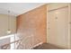 Hallway showcasing a brick wall and stairs leading to the entryway door at 8503 Canterbury W Sq # D, Indianapolis, IN 46260