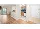 Hallway with wood floors leading to a kitchen and sliding door with access to a balcony at 8503 Canterbury W Sq # D, Indianapolis, IN 46260