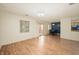 Living room and dining area featuring wood flooring, balcony access, and natural light at 8503 Canterbury W Sq # D, Indianapolis, IN 46260