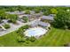 Aerial view of a community pool with lounge chairs surrounded by lush landscaping and residential buildings at 8503 Canterbury W Sq # D, Indianapolis, IN 46260