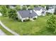 Aerial view of the backyard and neighborhood highlighting a mature lawn and landscaping at 8599 Lansdowne Dr, Fishers, IN 46038