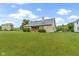 Wide view of the home's backyard, featuring a sprawling lawn and mature landscaping at 8599 Lansdowne Dr, Fishers, IN 46038