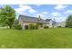 Beautiful backyard with a lush lawn, tasteful landscaping and covered patio at 8599 Lansdowne Dr, Fishers, IN 46038