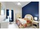 Cozy bedroom with a bold blue accent wall, and bright, cheerful furniture at 8599 Lansdowne Dr, Fishers, IN 46038