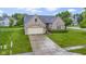 Charming brick home with attached garage, landscaped front yard, and inviting entryway at 8599 Lansdowne Dr, Fishers, IN 46038