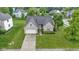 Charming brick home with attached garage, landscaped front yard, and inviting entryway at 8599 Lansdowne Dr, Fishers, IN 46038