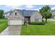 Charming brick home with attached garage, landscaped front yard, and inviting entryway at 8599 Lansdowne Dr, Fishers, IN 46038