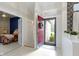 Bright foyer featuring an open doorway to a bedroom, red front door, and neutral flooring at 8599 Lansdowne Dr, Fishers, IN 46038