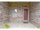 Close-up of the brick entryway, red front door with wreath, and decorative window at 8599 Lansdowne Dr, Fishers, IN 46038