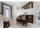 Elegant home office with a chandelier, built-in shelves, and large desk, with neutral carpet at 8599 Lansdowne Dr, Fishers, IN 46038