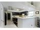 Bright kitchen with breakfast bar, pendant lighting, and dark cabinets at 8599 Lansdowne Dr, Fishers, IN 46038