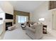Bright living room with a fireplace, large windows, and stylish furniture, with neutral carpet at 8599 Lansdowne Dr, Fishers, IN 46038