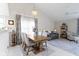 Open concept dining room with a large table and view to the living room at 8599 Lansdowne Dr, Fishers, IN 46038