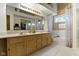 This main bathroom features a double vanity, large mirror, and combined bathtub and shower at 8599 Lansdowne Dr, Fishers, IN 46038