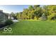 Large backyard with well-maintained lawn and mature trees providing shade and privacy at 865 Countryside Ln, Columbus, IN 47201