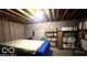Exposed ceiling in the unfinished basement with shelving to the side for organization at 865 Countryside Ln, Columbus, IN 47201