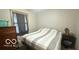 Bedroom featuring a bed, dresser, nightstand, and window at 865 Countryside Ln, Columbus, IN 47201