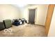 Neutral bedroom with a window and closet, needing TLC at 865 Countryside Ln, Columbus, IN 47201