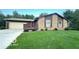Charming single-story home featuring a stone facade, cozy porch, and attached two-car garage at 865 Countryside Ln, Columbus, IN 47201