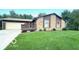 Charming single-story home featuring a spacious front yard, attached garage, and inviting front porch at 865 Countryside Ln, Columbus, IN 47201
