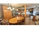 View of kitchen area with wood cabinets and stainless steel appliances open to dining area at 865 Countryside Ln, Columbus, IN 47201