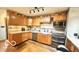 Well-lit kitchen featuring wooden cabinets, stainless steel appliances, and functional design at 865 Countryside Ln, Columbus, IN 47201