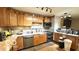 Spacious kitchen with wooden cabinets, stainless steel appliances, and tiled backsplash at 865 Countryside Ln, Columbus, IN 47201