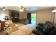 Comfortable living room with a stone fireplace and sliding glass door to the outdoors at 865 Countryside Ln, Columbus, IN 47201
