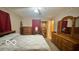 Spacious main bedroom with a large bed and an ornate dresser, mirror, and shelving unit at 865 Countryside Ln, Columbus, IN 47201
