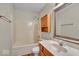 Bathroom features wood look floors, a tub/shower combo, and a marble look vanity at 8908 Sunningdale Blvd, Indianapolis, IN 46234