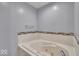 Bathroom featuring a large soaking tub with a tiled backsplash and chrome fixtures at 8908 Sunningdale Blvd, Indianapolis, IN 46234