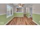 Bright dining room featuring wood-look floors, updated paint and views into the kitchen at 8908 Sunningdale Blvd, Indianapolis, IN 46234
