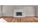 Spacious living room featuring a white brick fireplace and wood floors at 8908 Sunningdale Blvd, Indianapolis, IN 46234