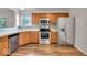 Well-lit kitchen with stainless steel appliances, granite countertops and wood-look flooring at 8908 Sunningdale Blvd, Indianapolis, IN 46234